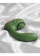 Swan Reign Rechargeable Silicone Dual Stimulating Vibrator Green on satin fabric background.