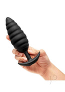 B-Vibe Twist Texture Silicone Vibrating Butt Plug Black held in hand, showcasing its unique twisted design for anal pleasure.