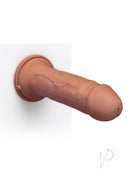 B-Vibe Girth 12 Inch Max Girth Suction Cup Dildo Caramel mounted on a wall, showcasing its lifelike design.