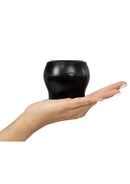 Kiiroo PowerBlow Interactive Suction Device Black held in a hand, showcasing its compact design and interactive features.