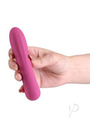 X and O's Tempt Silicone Compact Vibrator Magenta held in hand against a white background.