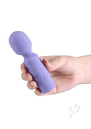 X and O's Adore Silicone Mini Vibrating Wand Blue held in hand, showcasing its compact design and soft silicone material.