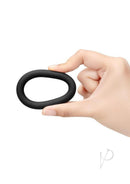 B-Vibe Snug Ring Thick Silicone Cock Ring 3 Pack Black in hand showcasing its soft, stretchy design.