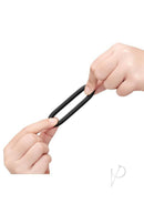 B-Vibe Snug Ring Lite Silicone Cock Ring 3 Pack Black held in hands, showcasing its stretchable design.