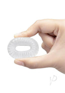 B-Vibe Stretch Tech Swirl Ultra Stretchy Cock Ring Clear held in a hand, showcasing its stretchy design and clarity.