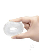B-Vibe Stretch Tech Drive Ultra Stretchy Cock Ring Clear held in hand, showcasing its extreme elasticity and minimalist design.