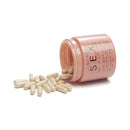 Bijoux Indiscrets Sex au Naturel Orgasm Glow Supplement 60 Pc capsules spilling from a pink container.