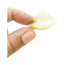 A hand holding a thin, minty strip from Bijoux Indiscrets Slow Sex Oral Sex Strips 7-pack.