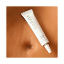 Bijoux Indiscrets Slow Sex Clitoral Balm 0.34 Oz tube positioned on bare skin.