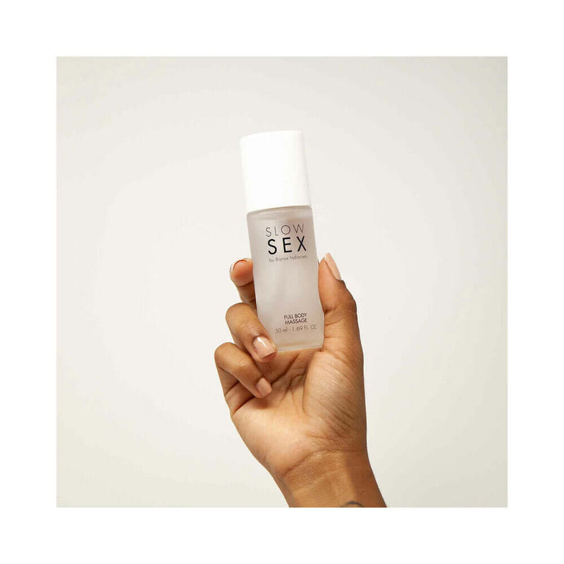 Bijoux Indiscrets Slow Sex Full Body Massage Gel 1.69 Oz held in a hand on a neutral background.