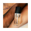 Bijoux Indiscrets Slow Sex Warming Massage Oil 1.69 Oz bottle shown on skin, emphasizing its kissable coconut flavor.