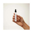 Bijoux Indiscrets Slow Sex Mouthwatering Spray 0.44 Oz held in a hand, showcasing its sleek design and spray nozzle.