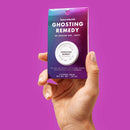 Bijoux Indiscrets Clitherapy Ghosting Remedy Clitoral Balm packaging held in hand with a vibrant background