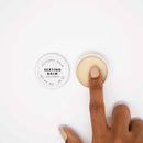 Image of Bijoux Indiscrets Clitherapy Sexting Clitoral Balm 0.28 Oz with a finger applying the balm.