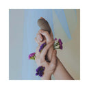 Bijoux Indiscrets Horoscope Kit Gemini with flowers and hands holding a sensual item, promoting exploration and connection.