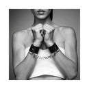 Bijoux Indiscrets Maze Wide Cuffs worn as statement cuffs with a silver chain for intimate play.