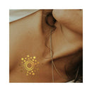 Bijoux Indiscrets Mimi Metallic Body Tattoos on skin with golden shimmer effect and pendant necklace.