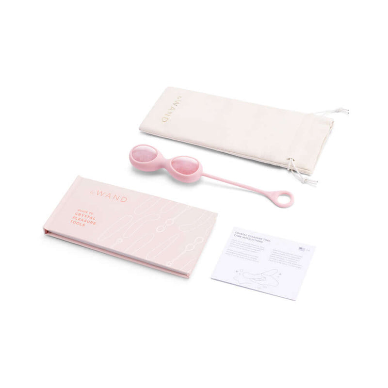 Le Wand Crystal Yoni Eggs Rose Quartz set including instructional booklet and storage pouch.