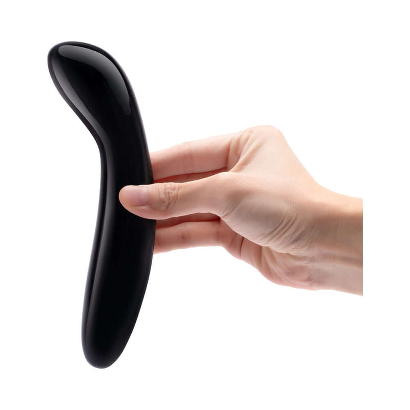 Le Wand Crystal G Wand Black Obsidian held in hand, showcasing its sleek design for intimate pleasure.