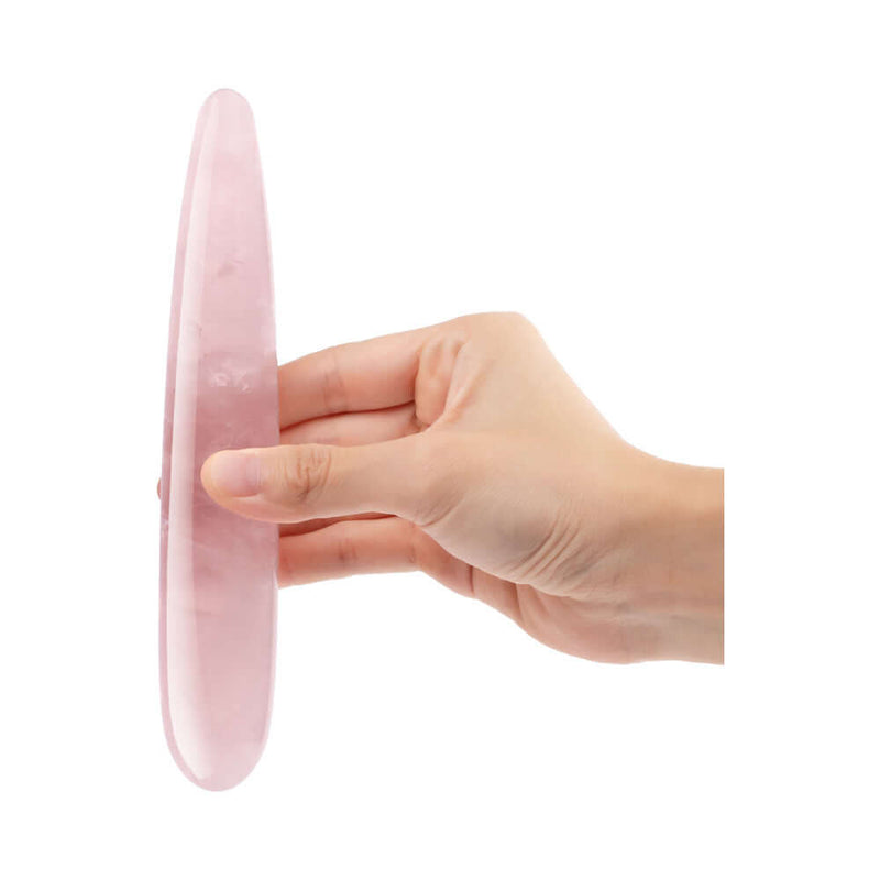Hand holding the Le Wand Crystal Slim Wand Rose Quartz, a crystal pleasure tool designed for self-love.