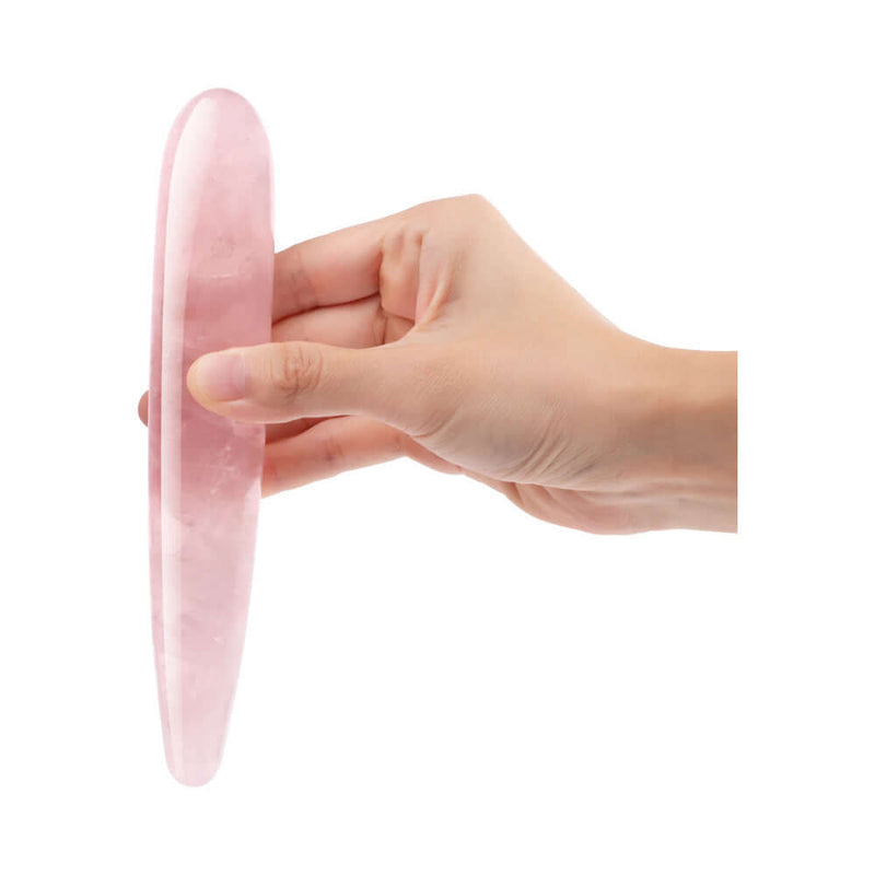 Le Wand Crystal Slim Wand Rose Quartz held in hand showcasing its sleek design and rose quartz material.