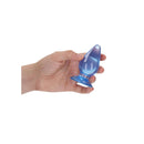 Realrock Crystal Clear Anal Plug 3.5 Inch Blue held in hand, showcasing its tapered tip and transparent design.