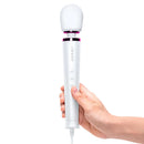 Le Wand Powerful Petite Plug-In Massager White held in hand, featuring a sleek design and soft head for ultimate relaxation.
