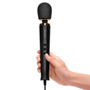 Le Wand Powerful Petite Plug-In Massager Black held in hand, showcasing its ergonomic design and plug-in functionality.