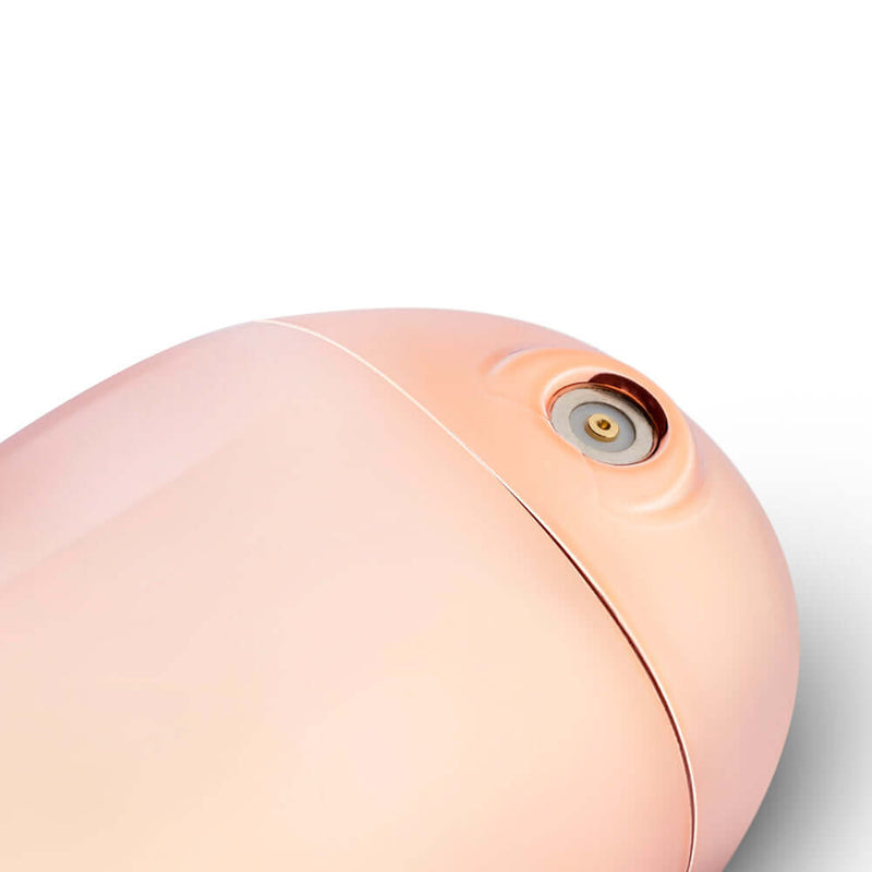 Close-up of Rosy Gold Nouveau Mini Massager showing the silky-soft silicone head and sleek design.