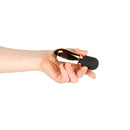 A person holding the Rosy Gold Nouveau Mini Massager in hand, showcasing its compact design and elegant finish.