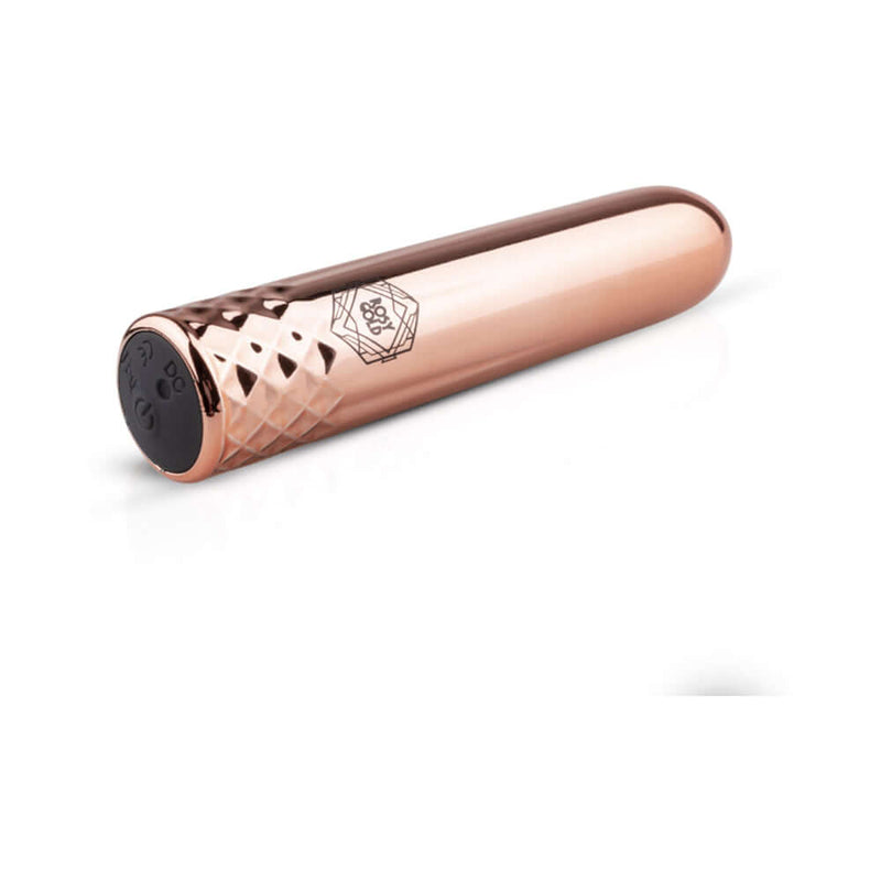 Rosy Gold Nouveau Mini Vibrator shown in elegant rose gold color with diamond pattern for sophistication and convenience.