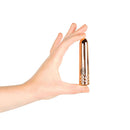 Hand holding the Rosy Gold Nouveau Mini Vibrator, showcasing its elegant and compact design.