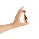 Hand holding the Rosy Gold Nouveau Butt Plug, showcasing its elegant design and luxurious finish.