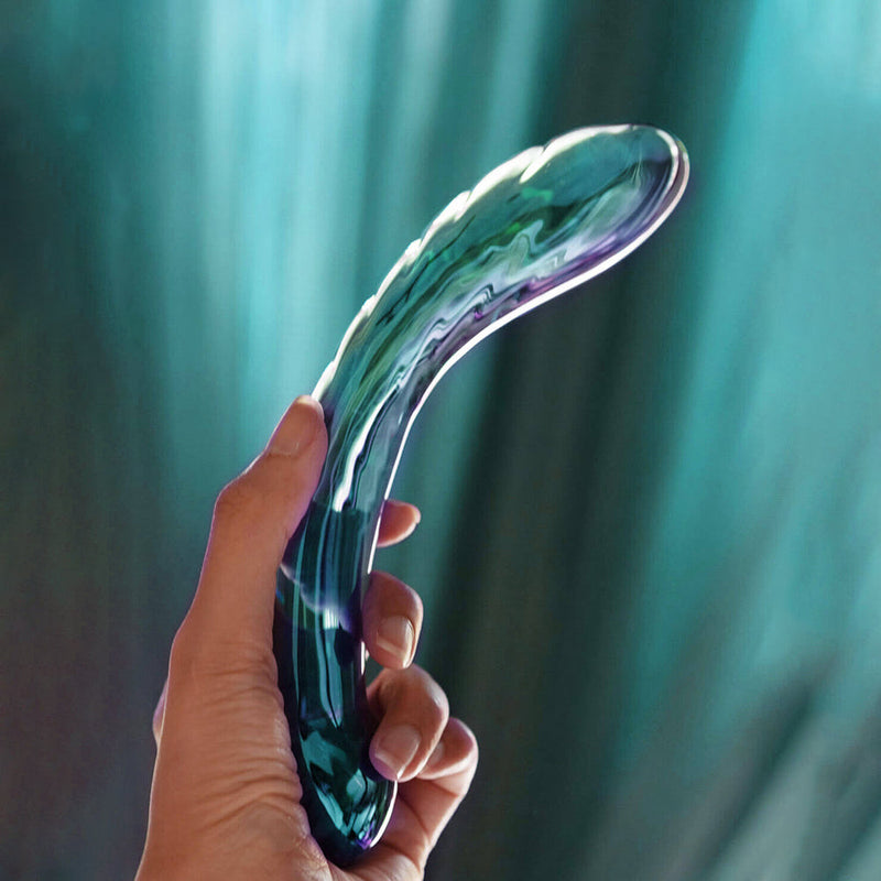 Biird Kalii Glass G Spot Dildo held in hand, showcasing its elegant design and curves for G-spot stimulation.