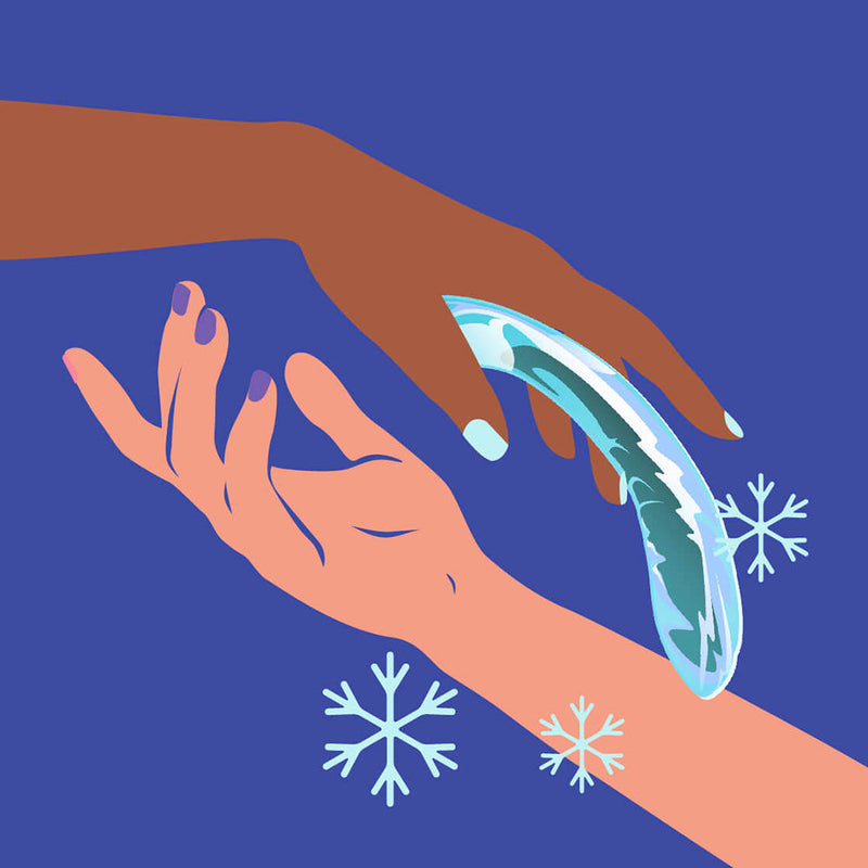 Biird Kalii Glass G spot Dildo being held by two hands over a blue background with snowflakes.
