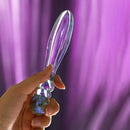 Biird Cecii Beaded Glass Dildo held in hand against a soft purple background, showcasing its elegant design.
