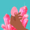 Biird Yonii 2 Piece Rose Quartz Eggs Set displayed with pink crystals and a hand holding one egg.