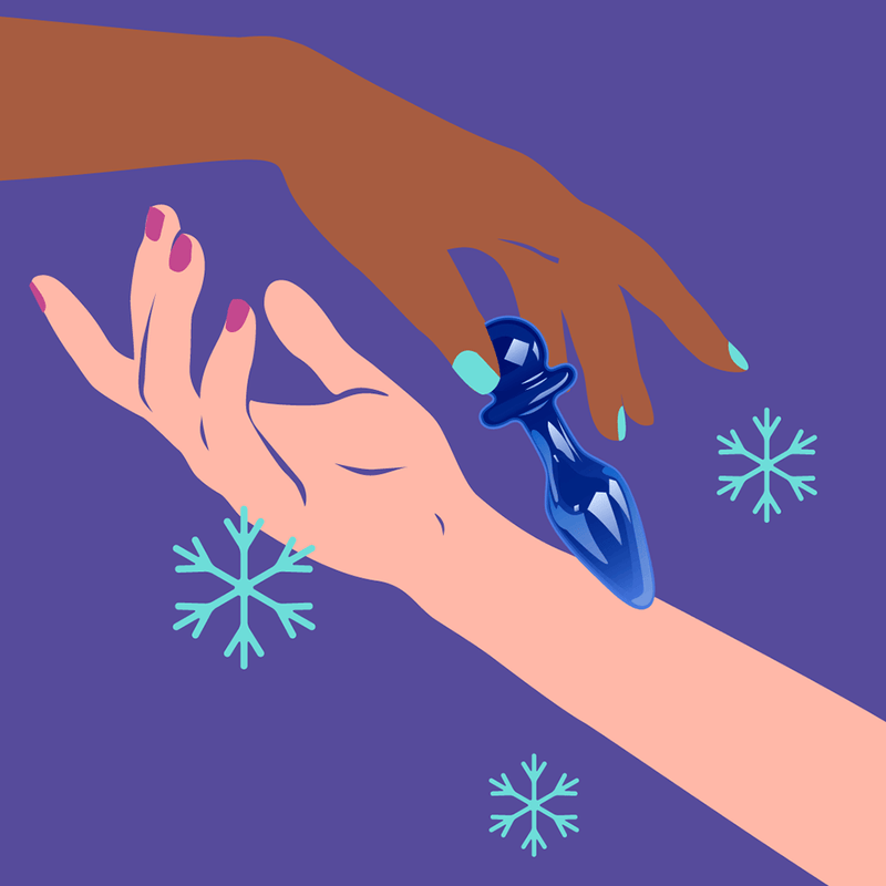 Two hands reaching for the Biird Anii Glass Anal Plug Blue on a purple background with snowflakes.