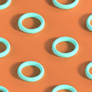 Biird Riin 3-Piece C-ring Set Mint showcasing mint-colored silicone rings against an orange background.