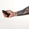 Hand holding the Je Joue Onyx Vibrating Butt Plug Black against a plain background.