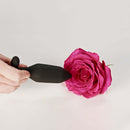 Je Joue Onyx Vibrating Butt Plug Black showcased next to a pink rose for sensual decoration.