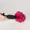 Je Joue Onyx Vibrating Butt Plug Black showcased next to a pink rose for sensual decoration.