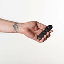 Je Joue Egon Vibrating Butt Plug Black held in hand, showcasing sleek design and control features.