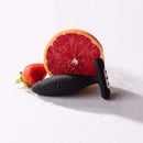 Je Joue Vesta Vibrating Butt Plug Black with fresh fruit, showcasing its luxurious design and ergonomic features.