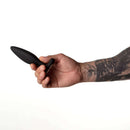 Je Joue Vesta Vibrating Butt Plug Black held in hand, showcasing its ergonomic design for anal stimulation.