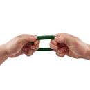Hands stretching the Shaft Model R C Ring Green Size 2 showcasing its flexible design.