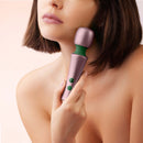 FemmeFunn Bougie Wand Rose Gold held by a woman, showcasing its elegant design and functionality.