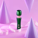 FemmeFunn Bougie Wand Massager Green surrounded by purple party hats and ribbons on a pastel background.