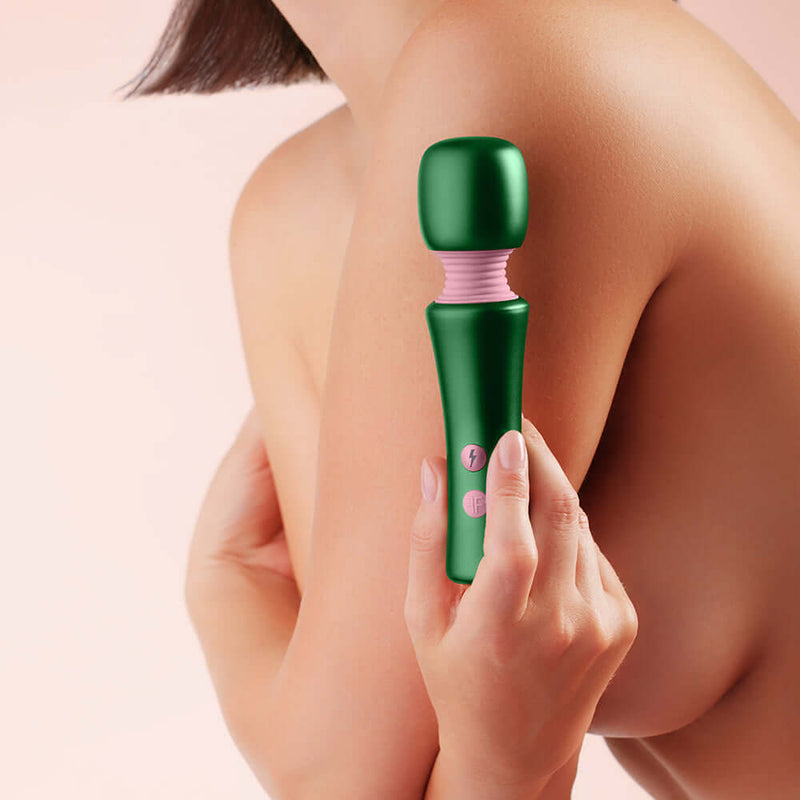 FemmeFunn Bougie Wand Massager Green held against a bare shoulder, showcasing its sleek design and powerful features.