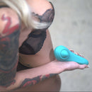 Close-up of a person holding the Hot Octopuss Pulse Queen Vibrator in a stylish blue design.